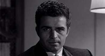 Movie still from “Murder by Contract” (1958), directed by Irving Lerner – Black and white photograph of a man in a suit and tie; Close Up shot, Low angle