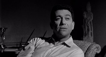 Movie still from “Murder by Contract” (1958), directed by Irving Lerner – Black and white photograph of a man in a white shirt; Close Up shot, Low angle