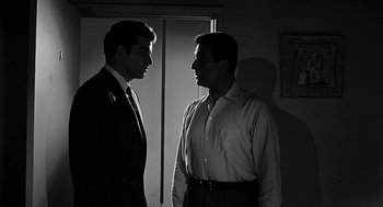 Movie still from “Murder by Contract” (1958), directed by Irving Lerner – A couple of men standing next to each other; Close Up shot, Low angle