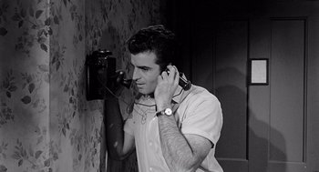 Movie still from “Murder by Contract” (1958), directed by Irving Lerner – A young man is talking on a phone; Close Up shot, High angle