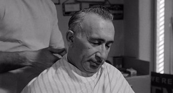 Movie still from “Murder by Contract” (1958), directed by Irving Lerner – An older man getting his hair combed by a barber; Close Up shot, Low angle