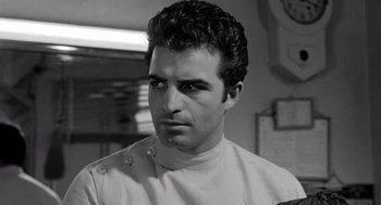Movie still from “Murder by Contract” (1958), directed by Irving Lerner – Black and white photograph of a man in a kitchen; Close Up shot, Low angle