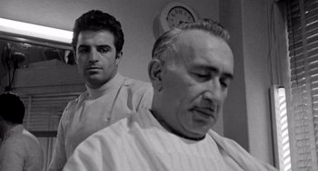Movie still from “Murder by Contract” (1958), directed by Irving Lerner – A man getting his hair combed by another man; Close Up shot, Low angle