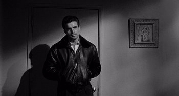 Movie still from “Murder by Contract” (1958), directed by Irving Lerner – A black and white photo of a man in a leather jacket; Medium shot, Over the shoulder angle