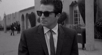 Movie still from “Murder by Contract” (1958), directed by Irving Lerner – A black and white photo of a man in a suit and tie; Close Up shot, Low angle