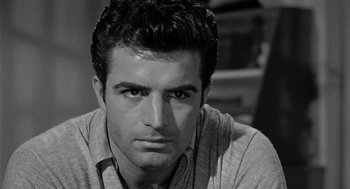 Movie still from “Murder by Contract” (1958), directed by Irving Lerner – Black and white photograph of a man with headphones; Close Up shot, Over the shoulder angle