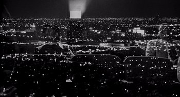 Movie still from “Murder by Contract” (1958), directed by Irving Lerner – A black - and - white photo of a city at night; Extreme Wide shot, High angle