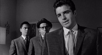 Movie still from “Murder by Contract” (1958), directed by Irving Lerner – A group of men standing next to each other in a room; Close Up shot, Low angle