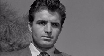 Movie still from “Murder by Contract” (1958), directed by Irving Lerner – Black and white photograph of a man in a suit and tie; Close Up shot, Low angle