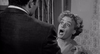 Movie still from “Murder by Contract” (1958), directed by Irving Lerner – An old black and white photo of a man and a woman; Close Up shot, Over the shoulder angle