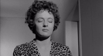 Movie still from “Murder by Contract” (1958), directed by Irving Lerner – A woman with her eyes closed with her eyes closed; Close Up shot, Low angle
