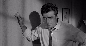 Movie still from “Murder by Contract” (1958), directed by Irving Lerner – Black and white photograph of a man in a shirt and tie; Close Up shot, Low angle