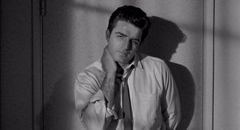 Movie still from “Murder by Contract” (1958), directed by Irving Lerner – Black and white photograph of a man in a shirt and tie; Close Up shot, Low angle