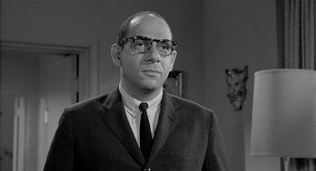 Movie still from “Murder by Contract” (1958), directed by Irving Lerner – An older man wearing glasses and a suit; Close Up shot, Low angle