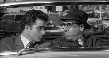Movie still from “Murder by Contract” (1958), directed by Irving Lerner – Two men sitting in the back seat of a car; Close Up shot, Over the shoulder angle