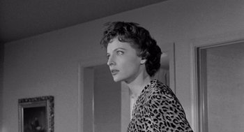 Movie still from “Murder by Contract” (1958), directed by Irving Lerner – An old photo of a woman in a leopard print shirt; Close Up shot, Low angle