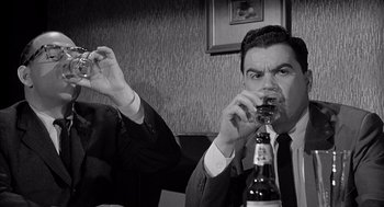 Movie still from “Murder by Contract” (1958), directed by Irving Lerner – A black and white photo of a man drinking a glass of wine; Close Up shot, Low angle