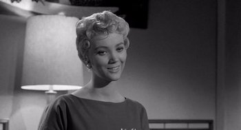 Movie still from “Murder by Contract” (1958), directed by Irving Lerner – A black and white photo of a woman smiling for the camera; Close Up shot, Low angle