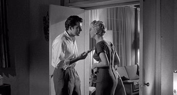 Movie still from “Murder by Contract” (1958), directed by Irving Lerner – A man and a woman are standing in front of each other; Medium shot, Over the shoulder angle