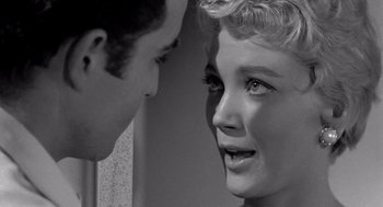 Movie still from “Murder by Contract” (1958), directed by Irving Lerner – A man and a woman face to face in a black and white photo; Close Up shot, Over the shoulder angle