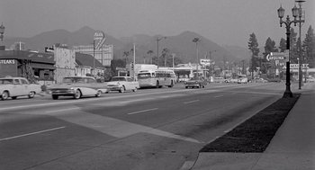 Movie still from “Murder by Contract” (1958), directed by Irving Lerner – A black - and - white photo of cars on a street; Extreme Wide shot, High angle