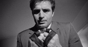 Movie still from “Murder by Contract” (1958), directed by Irving Lerner – A black and white photo of a man wearing a suit and tie; Close Up shot, Low angle