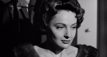 Movie still from “Murder by Contract” (1958), directed by Irving Lerner – An old photo of a woman in a fur coat; Close Up shot, Low angle