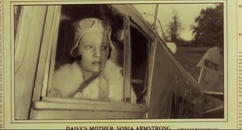 Movie still from “Murder on the Orient Express” (1974), directed by Sidney Lumet – An old photo of a woman sitting in the window of an airplane; Close Up shot, Low angle