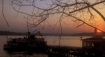 Movie still from “Murder on the Orient Express” (1974), directed by Sidney Lumet – A boat on the water near a pier at sunset; Extreme Wide shot, Low angle