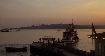 Movie still from “Murder on the Orient Express” (1974), directed by Sidney Lumet – A boat in the middle of a body of water at dusk; Extreme Wide shot, Low angle