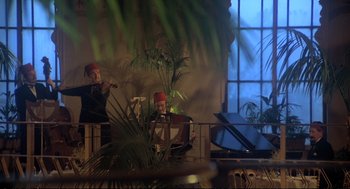 Movie still from “Murder on the Orient Express” (1974), directed by Sidney Lumet – Two people are sitting in a room with a piano; Wide shot, Low angle