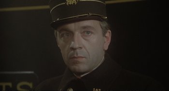 Movie still from “Murder on the Orient Express” (1974), directed by Sidney Lumet – A person wearing a uniform; Close Up shot, High angle