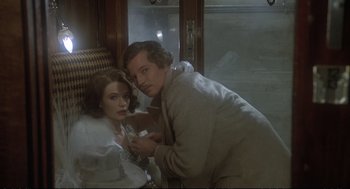 Movie still from “Murder on the Orient Express” (1974), directed by Sidney Lumet – A man and a woman are sitting on a train; Medium shot, Over the shoulder angle
