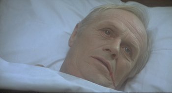 Movie still from “Murder on the Orient Express” (1974), directed by Sidney Lumet – An old man laying in a bed with white sheets; Close Up shot, High angle