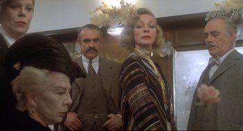 Movie still from “Murder on the Orient Express” (1974), directed by Sidney Lumet – A man and a woman standing next to each other in front of a mirror; Medium shot, Low angle