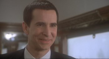 Movie still from “Murder on the Orient Express” (1974), directed by Sidney Lumet – A person wearing a suit and tie; Close Up shot, Over the shoulder angle