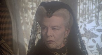 Movie still from “Murder on the Orient Express” (1974), directed by Sidney Lumet – An older woman wearing a black dress and a veil; Close Up shot, Over the shoulder angle
