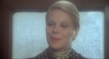 Movie still from “Murder on the Orient Express” (1974), directed by Sidney Lumet – An older woman with blonde hair wearing a black and white dress; Close Up shot, Over the shoulder angle