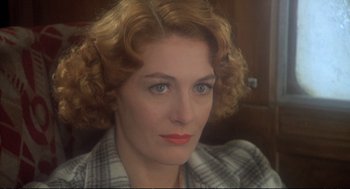 Movie still from “Murder on the Orient Express” (1974), directed by Sidney Lumet – A person wearing a plaid shirt; Close Up shot, Over the shoulder angle