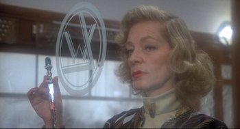 Movie still from “Murder on the Orient Express” (1974), directed by Sidney Lumet – A woman is looking at a vw sign through a window; Close Up shot, Low angle