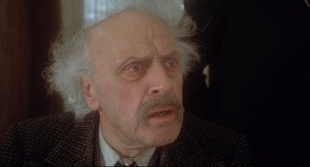 Movie still from “Murder on the Orient Express” (1974), directed by Sidney Lumet – An old man with a white beard is looking at the camera; Close Up shot, Low angle