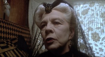 Movie still from “Murder on the Orient Express” (1974), directed by Sidney Lumet – An older woman wearing a black dress and a black veil; Close Up shot, Low angle