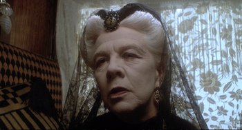 Movie still from “Murder on the Orient Express” (1974), directed by Sidney Lumet – An older woman wearing a black dress and a black veil; Close Up shot, Low angle