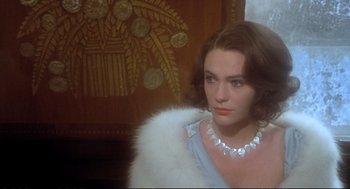 Movie still from “Murder on the Orient Express” (1974), directed by Sidney Lumet – A woman wearing a necklace and a white fur collar; Close Up shot, Over the shoulder angle