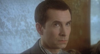 Movie still from “Murder on the Orient Express” (1974), directed by Sidney Lumet – A person wearing a suit and tie; Close Up shot, High angle