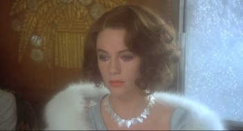 Movie still from “Murder on the Orient Express” (1974), directed by Sidney Lumet – A person wearing a necklace; Close Up shot, Over the shoulder angle