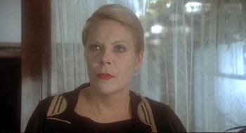Movie still from “Murder on the Orient Express” (1974), directed by Sidney Lumet – A person wearing a black shirt; Close Up shot, Over the shoulder angle