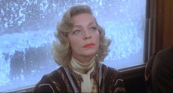 Movie still from “Murder on the Orient Express” (1974), directed by Sidney Lumet – An older woman with blonde curly hair wearing a jacket; Close Up shot, Low angle
