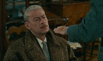 Movie still from “Muriel” (1963), directed by Alain Resnais – An older man is being shaved by an older woman; Close Up shot, Over the shoulder angle