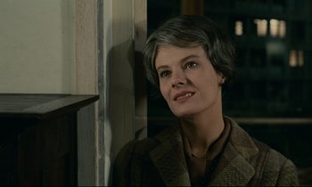 Movie still from “Muriel” (1963), directed by Alain Resnais – An older woman with short grey hair looking at the camera; Close Up shot, Low angle